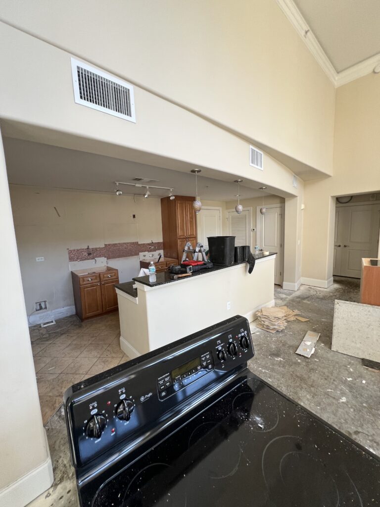 Upper kitchen cabinets removed during demolition.